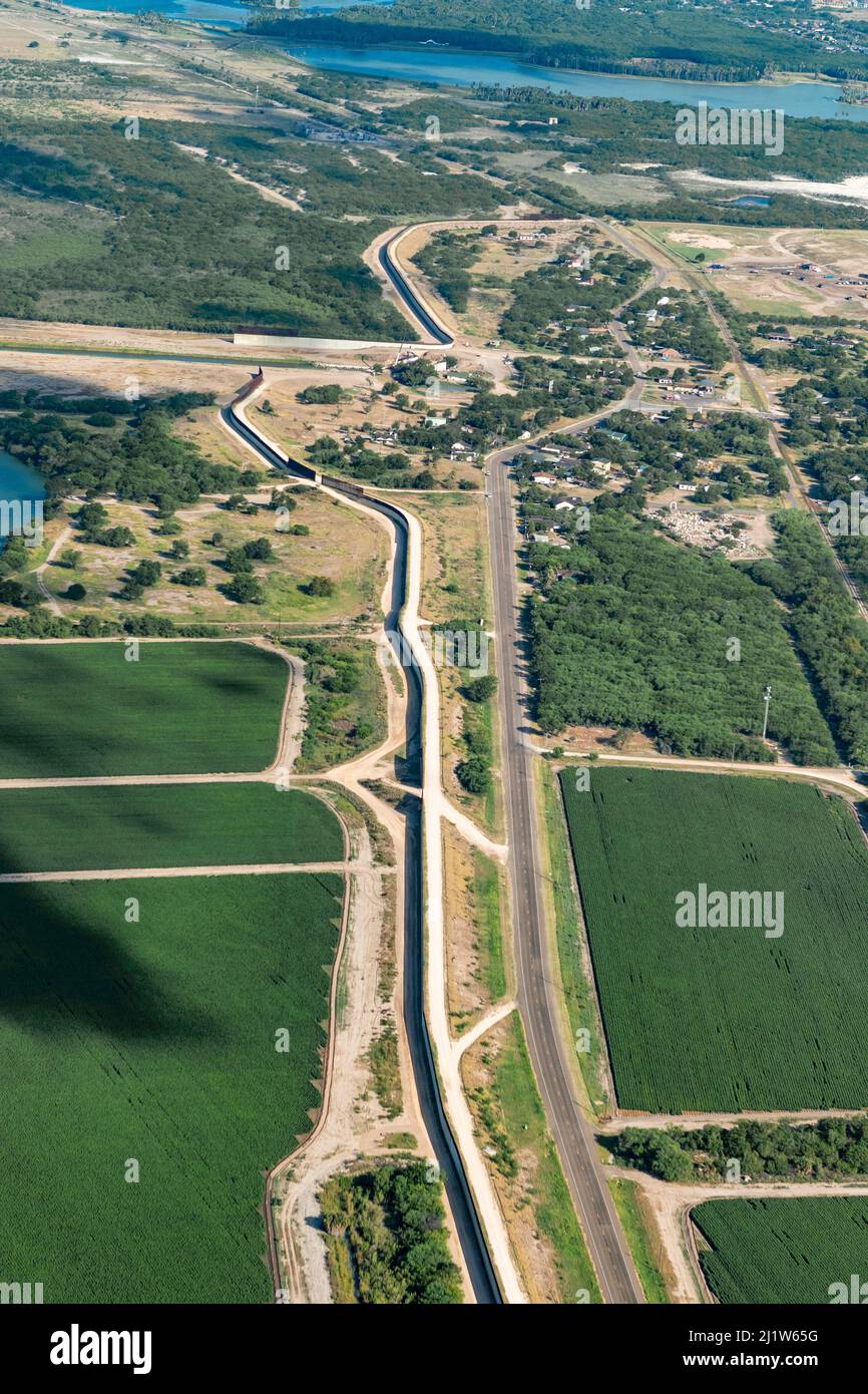 Border wall through agricultural land in Rio Grande Valley, aerial view. Mission, Hidalgo County, Texas, USA. July 2019. Stock Photo