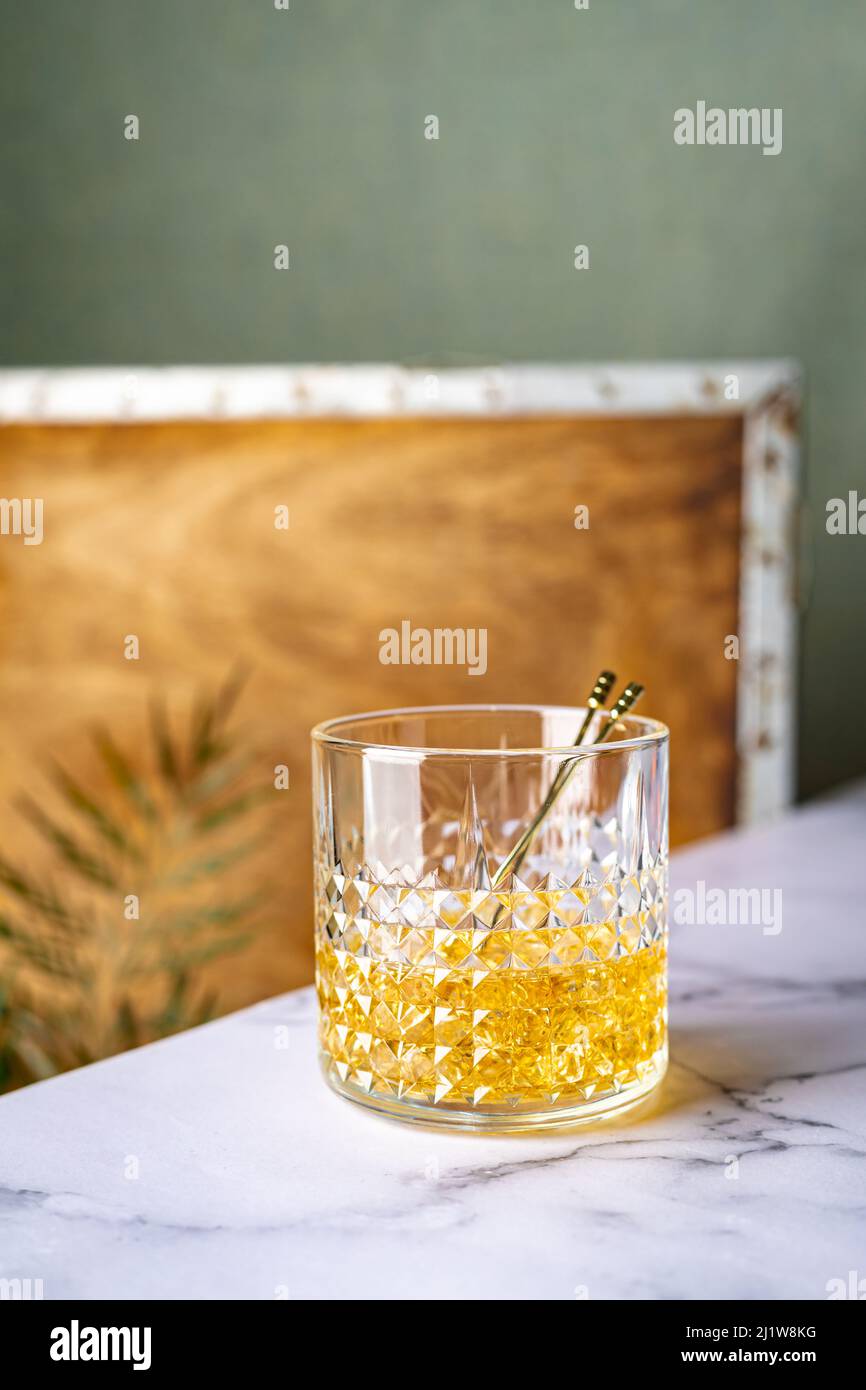 Crystal glass with whiskey served on marble table Stock Photo