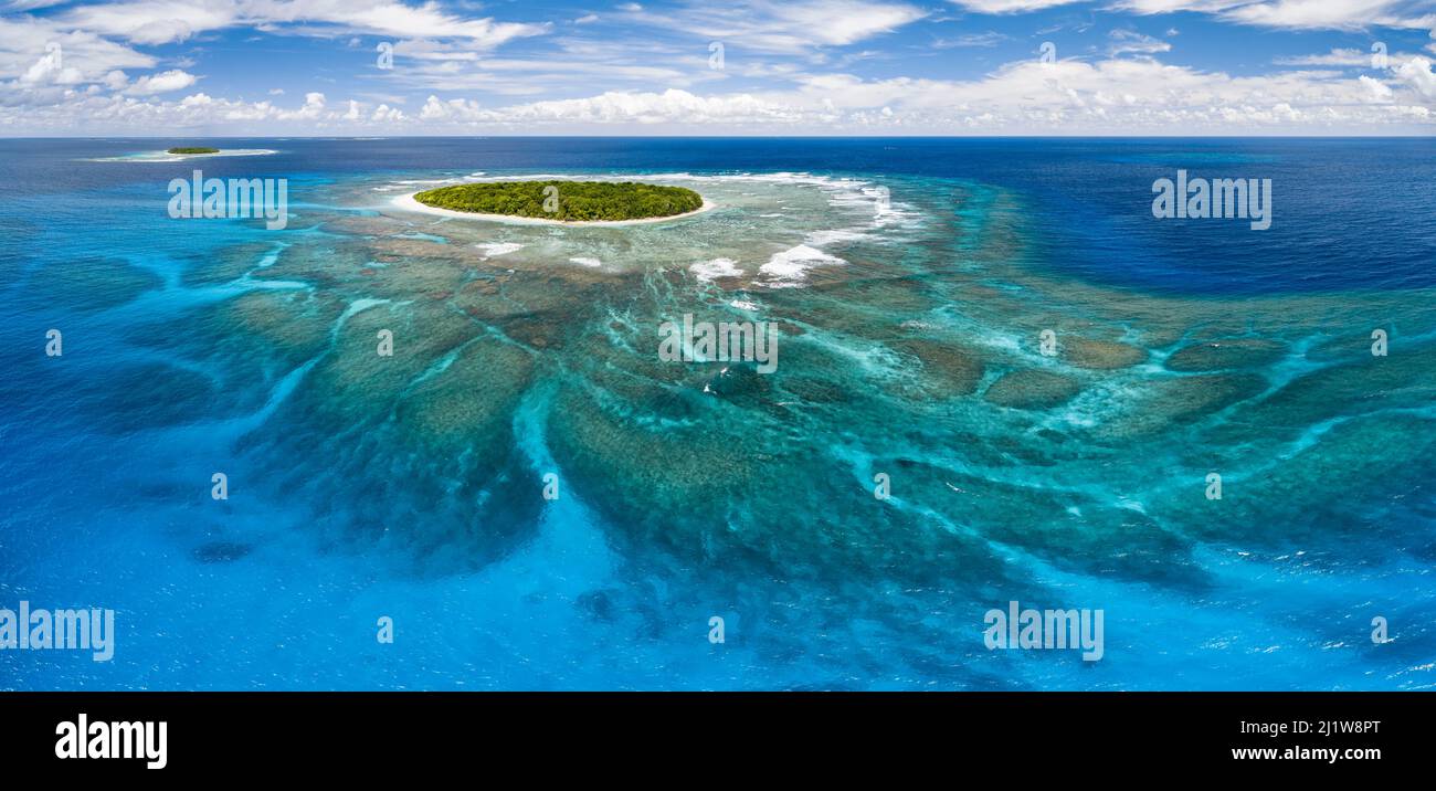 Aerial panorama of Fangasito Island with the underwater coral reef