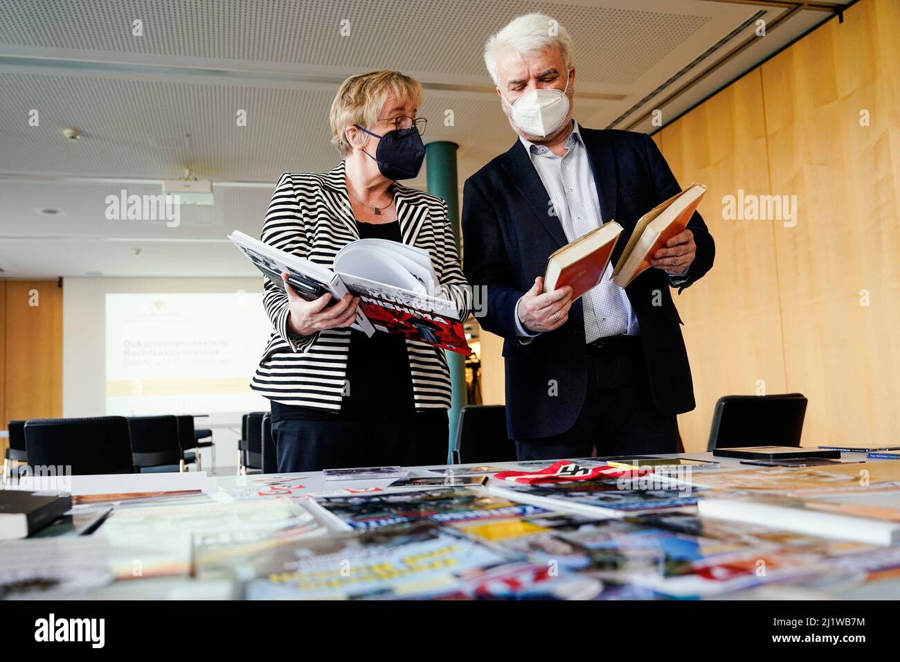 Karlsruhe, Germany. 28th Mar, 2022. Theresia Bauer (Bündnis 90/Die Grünen), Baden-Württemberg's Minister of Science, and Wolfgang Zimmermann, Director of the Generallandesarchiv, look at books in the collection after a press conference at the Documentation Center for Right-Wing Extremism in the Landesarchiv Baden-Württemberg. Almost two years after the founding of the Documentation Center on Right-Wing Extremism, Science Minister Bauer takes stock. Credit: Uwe Anspach/dpa/Alamy Live News Stock Photo