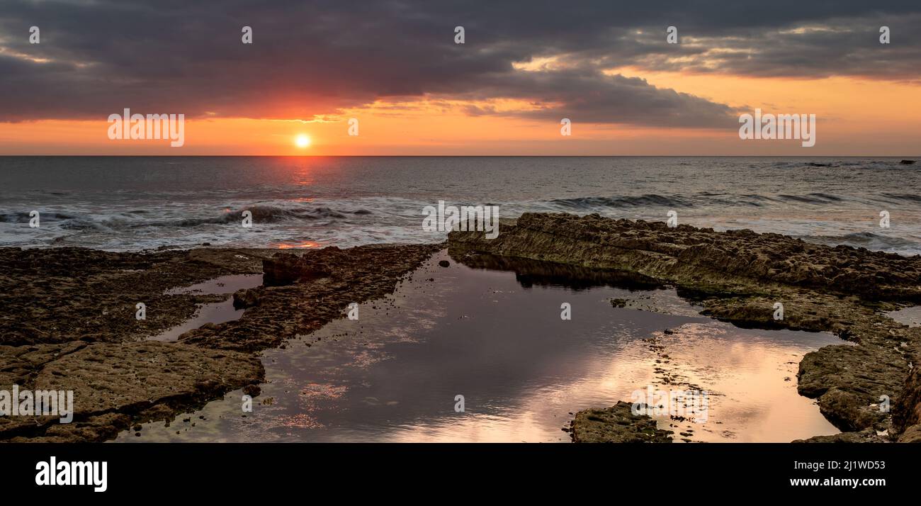 Summer sunrise on Thornwick Bay, Yorkshire ,UK Stock Photo