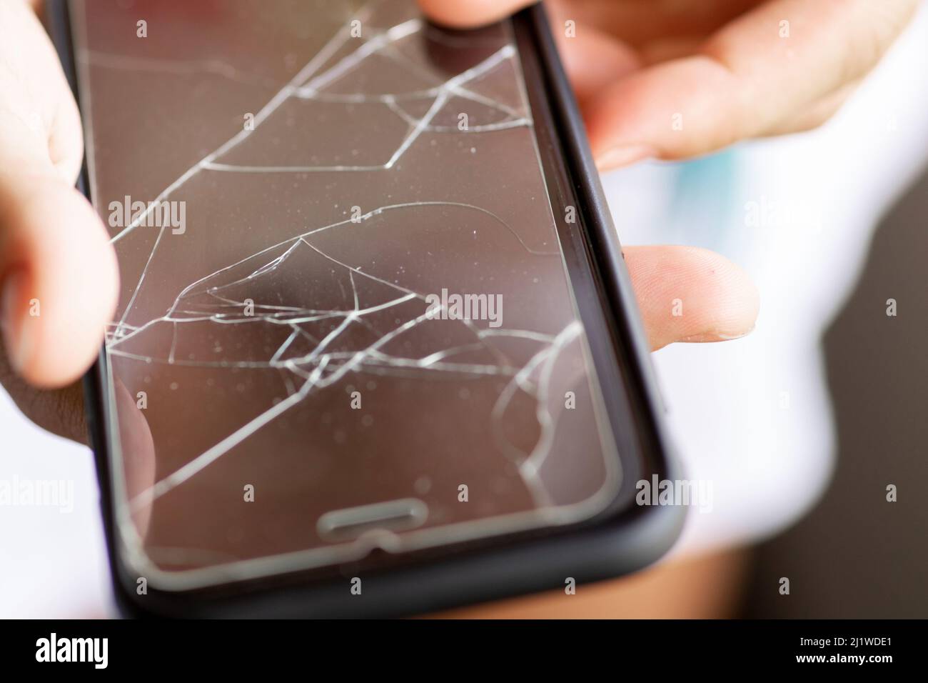 Broken protective film on a smartphone display Stock Photo