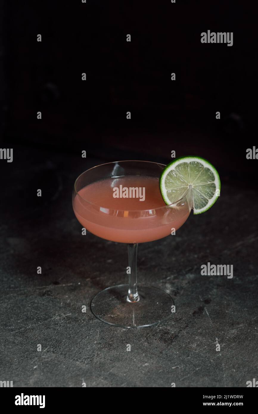 Hemingway daiquiri grapefruit gin cocktail with lime wheel Stock Photo