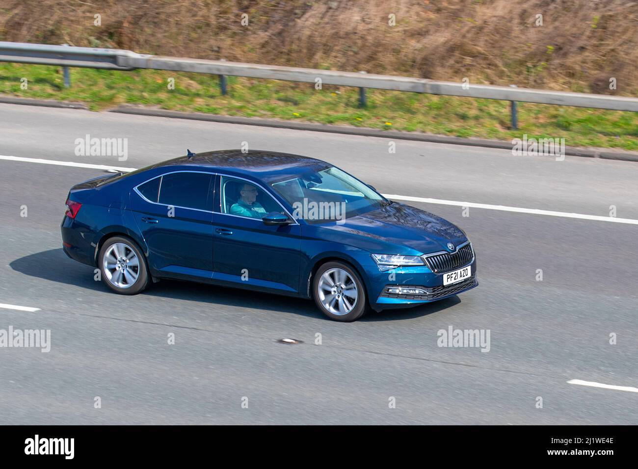 2021 blue Skoda Superb SE L TSi S-E L DSG 7 speed automatic; driving on the M61 near Manchester, UK Stock Photo
