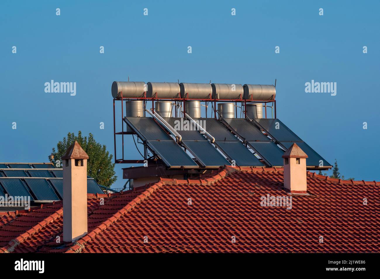solar thermal collectors installed on the tiled roof of the house Stock ...