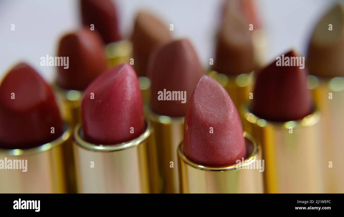 Closeup of tubes of lipsticks in different hues of red. Stock Photo