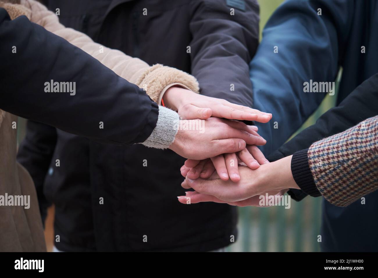 Multiracial group of friends with hands in stack. Teamwork concept. Stock Photo