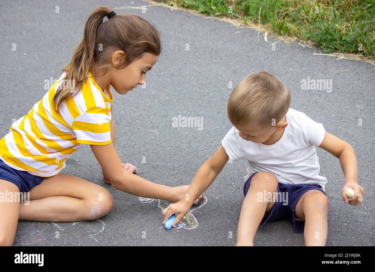 children draw on the pavement with chalk. Very good weather Stock Photo ...