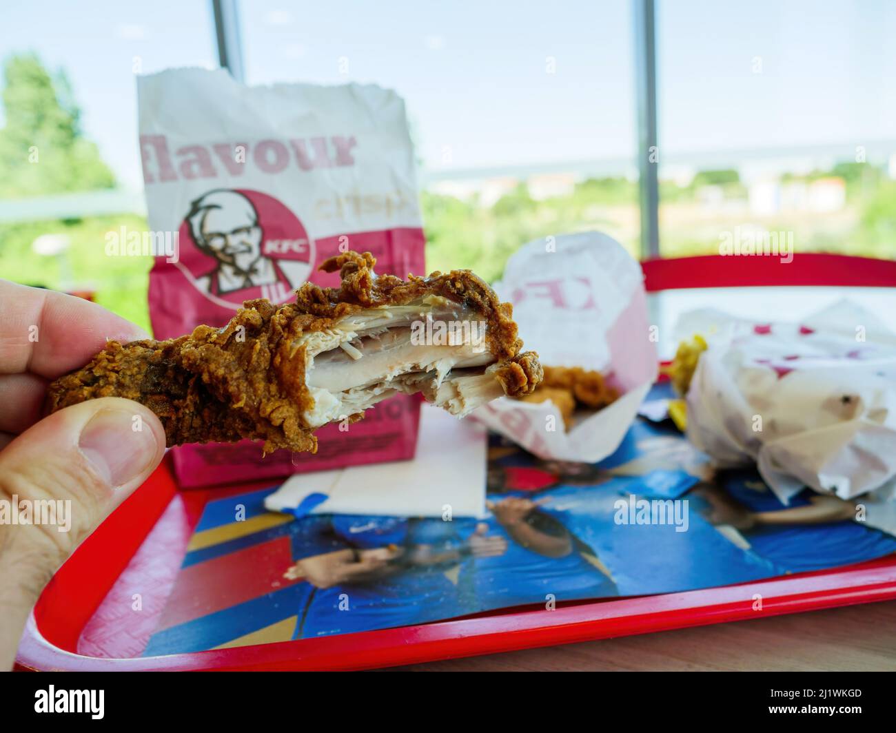 France June 28 18 Pov Male Hand Holding Chicken Part Meat With Tray On A Table In The Kfc Fast Food Stock Photo Alamy