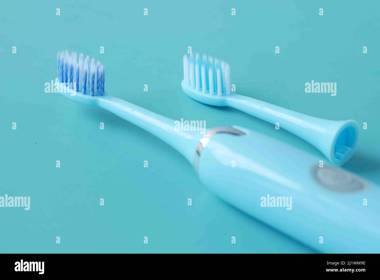 a blue color electronic toothbrushes on blue background  Stock Photo