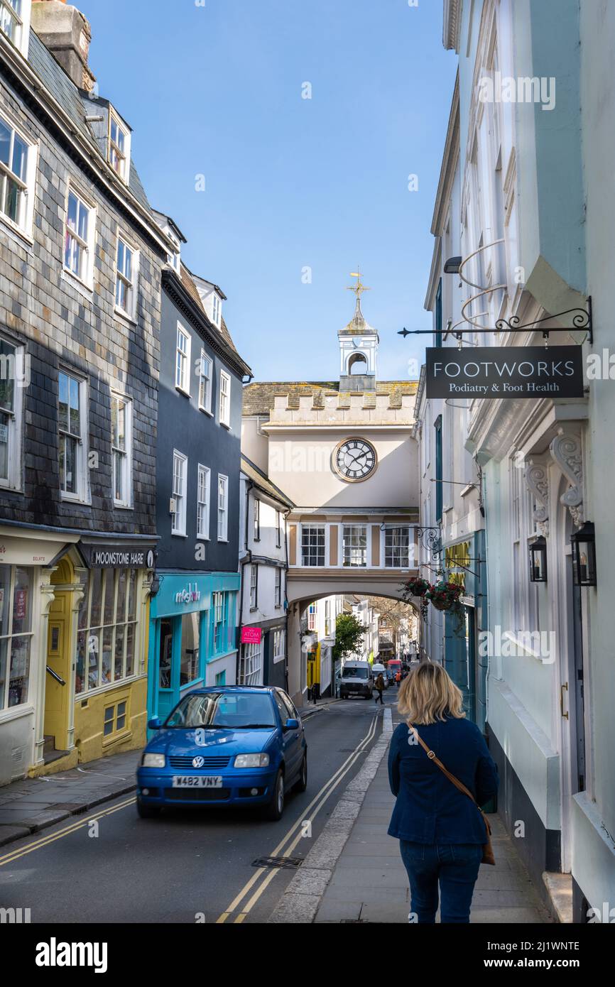 Clock in archway over the narrow high street, one way traffic, Totnes, Devon, UK Stock Photo