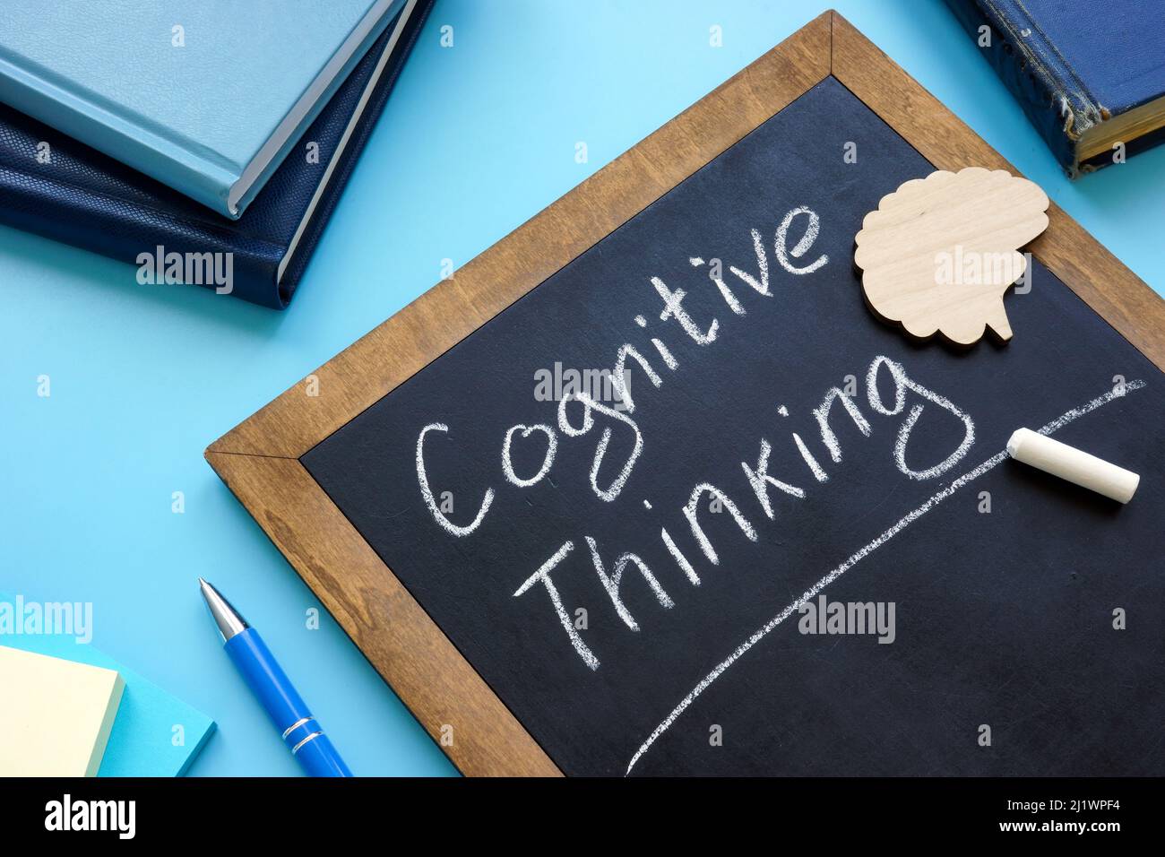 Cognitive thinking handwritten on the blackboard and brain. Stock Photo