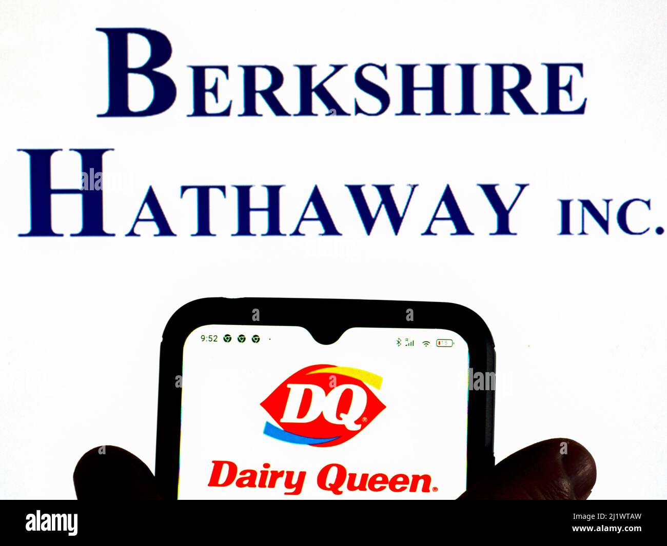Germany. 28th Mar, 2022. In this photo illustration, the Dairy Queen logo is displayed on a smartphone screen with a Berkshire Hathaway Inc. logo in the background. (Photo by Igor Golovniov/SOPA Images/Sipa USA) Credit: Sipa USA/Alamy Live News Stock Photo