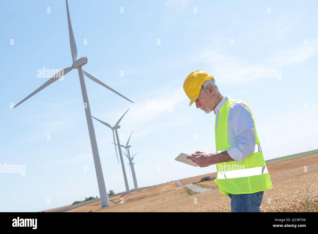 Electrical engineer using digital tablet for wind turbine inspection