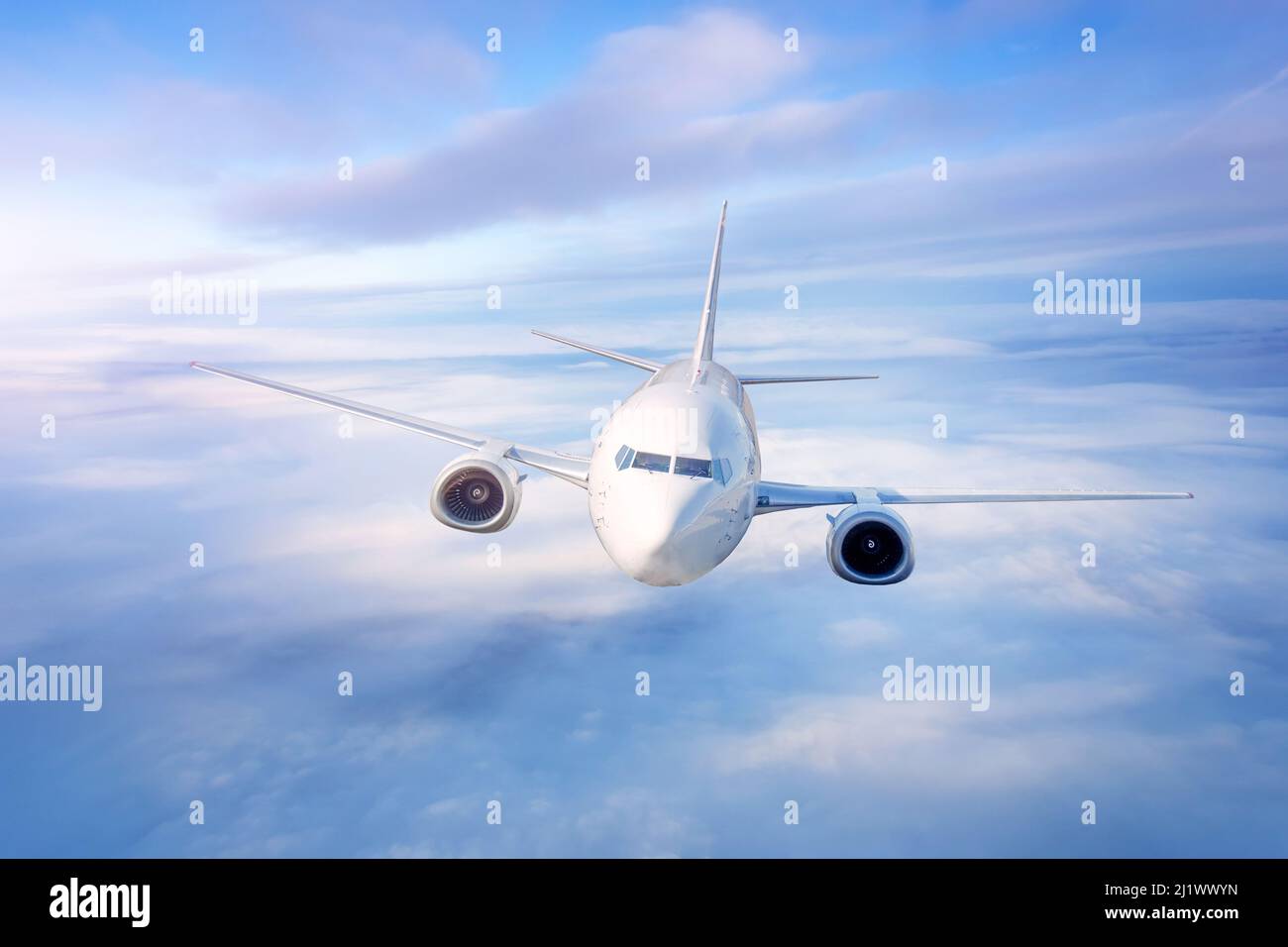 Airplane above the clouds in the sky at sunrise, twilight flight Stock ...