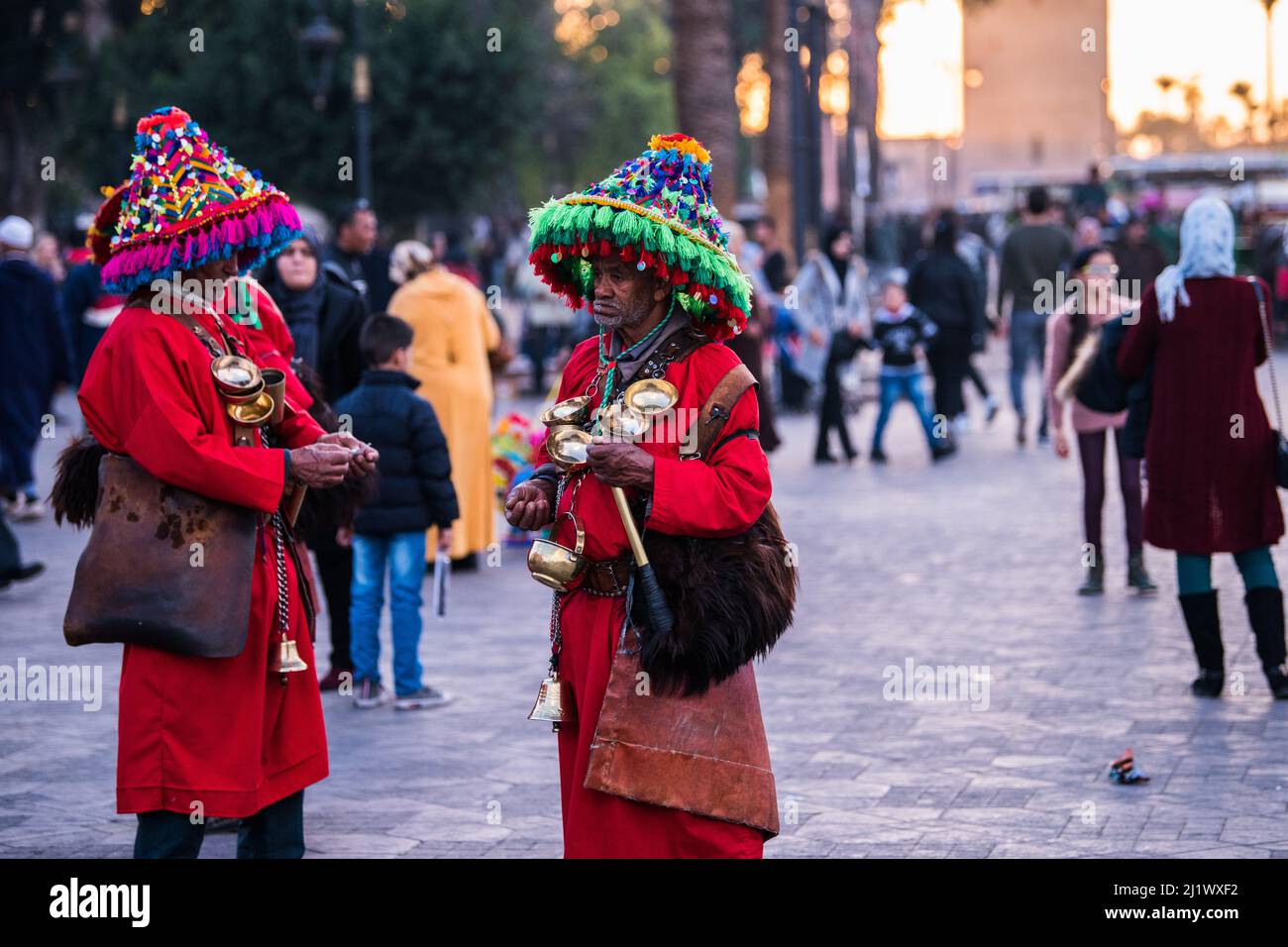 Marrakesh, Morocco - February 28, 2022: Moroccan water seller in traditional costume selling water on Djemaa el Fna square of Medina district of Marra Stock Photo