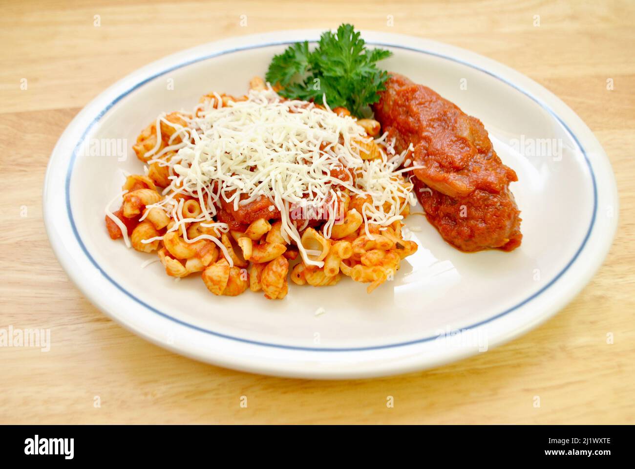 Shell and Elbow Pasta with Sauce and Cheese and a Sausage on the Side