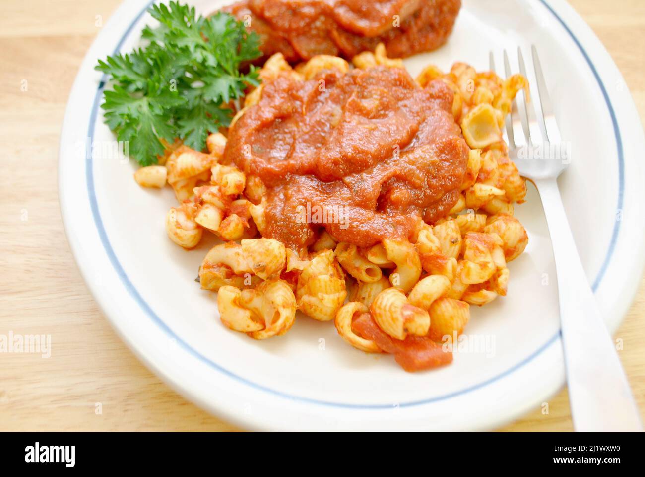 Close Up of a Pasta with Hot Spicy Sausage in the Background Stock Photo