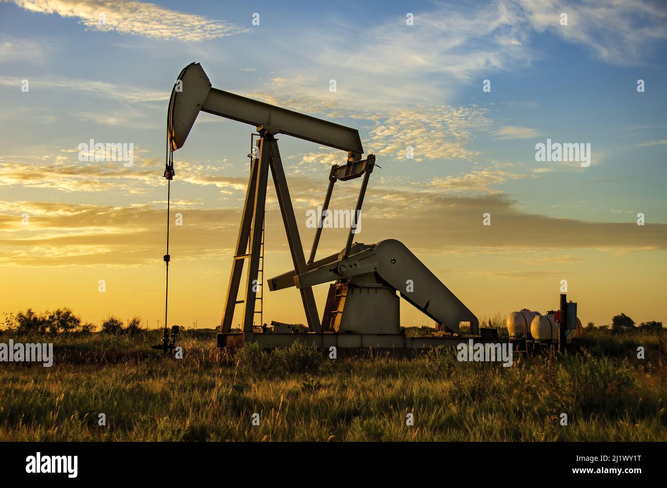 Working Oil rig during sunrise or sunset under a blue sky Stock Photo ...
