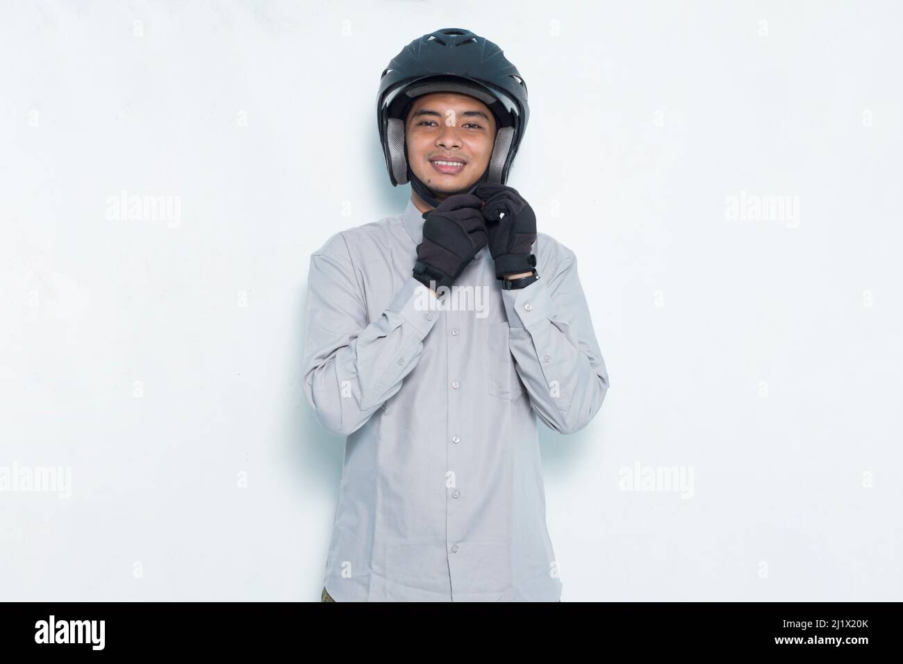 portrait handsome asian man with a motorcycle waring helmet on white background Stock Photo