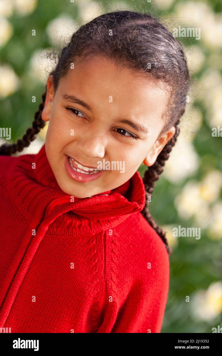 Beautiful young African American mixed race girl standing smiling in a