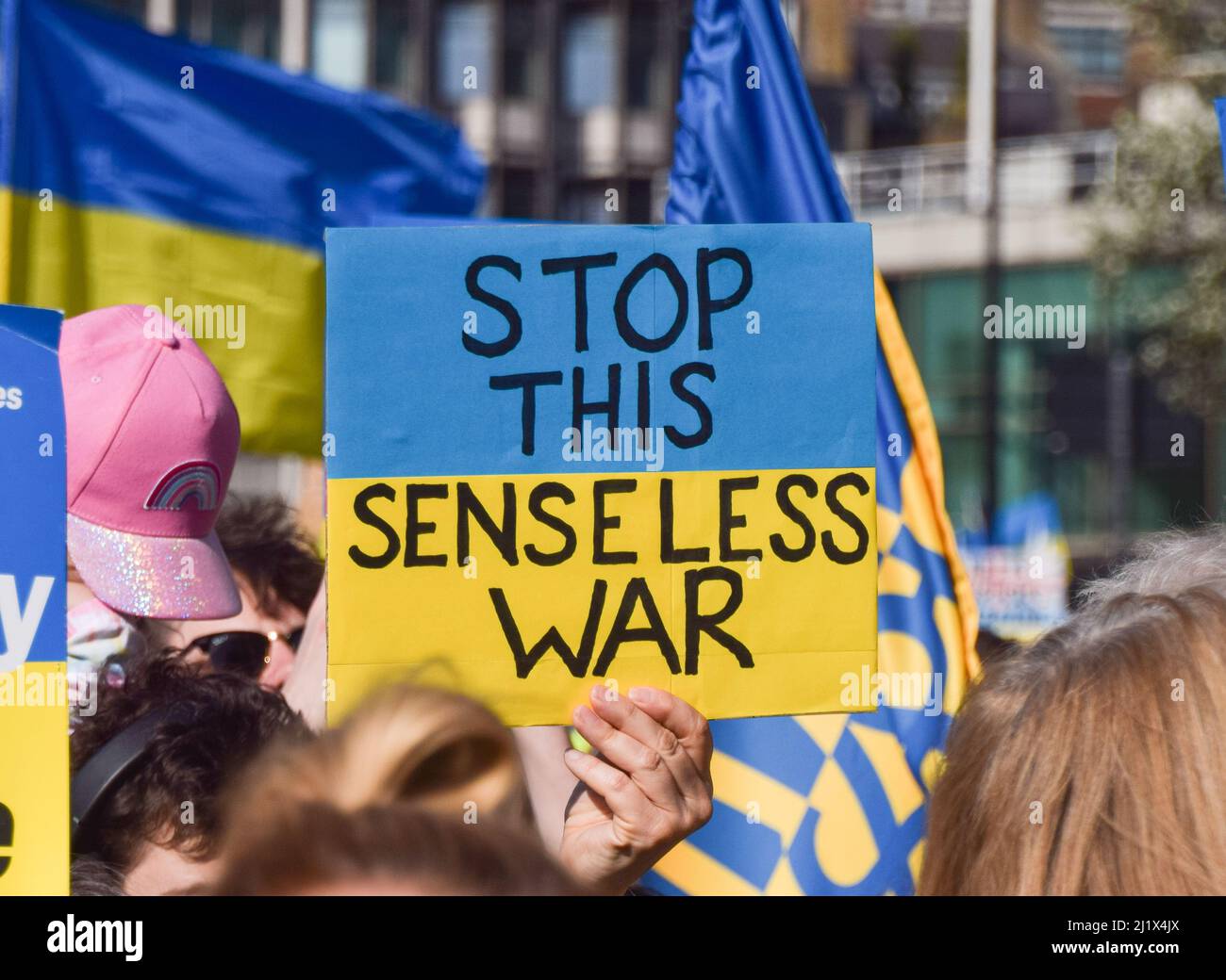 London, UK. 26th March 2022. A protester in Park Lane holds a sign which reads 'Stop this senseless war', during the London Stands With Ukraine march. Thousands of people marched from Park Lane to Trafalgar Square in solidarity with Ukraine as Russia continues its attack. Stock Photo