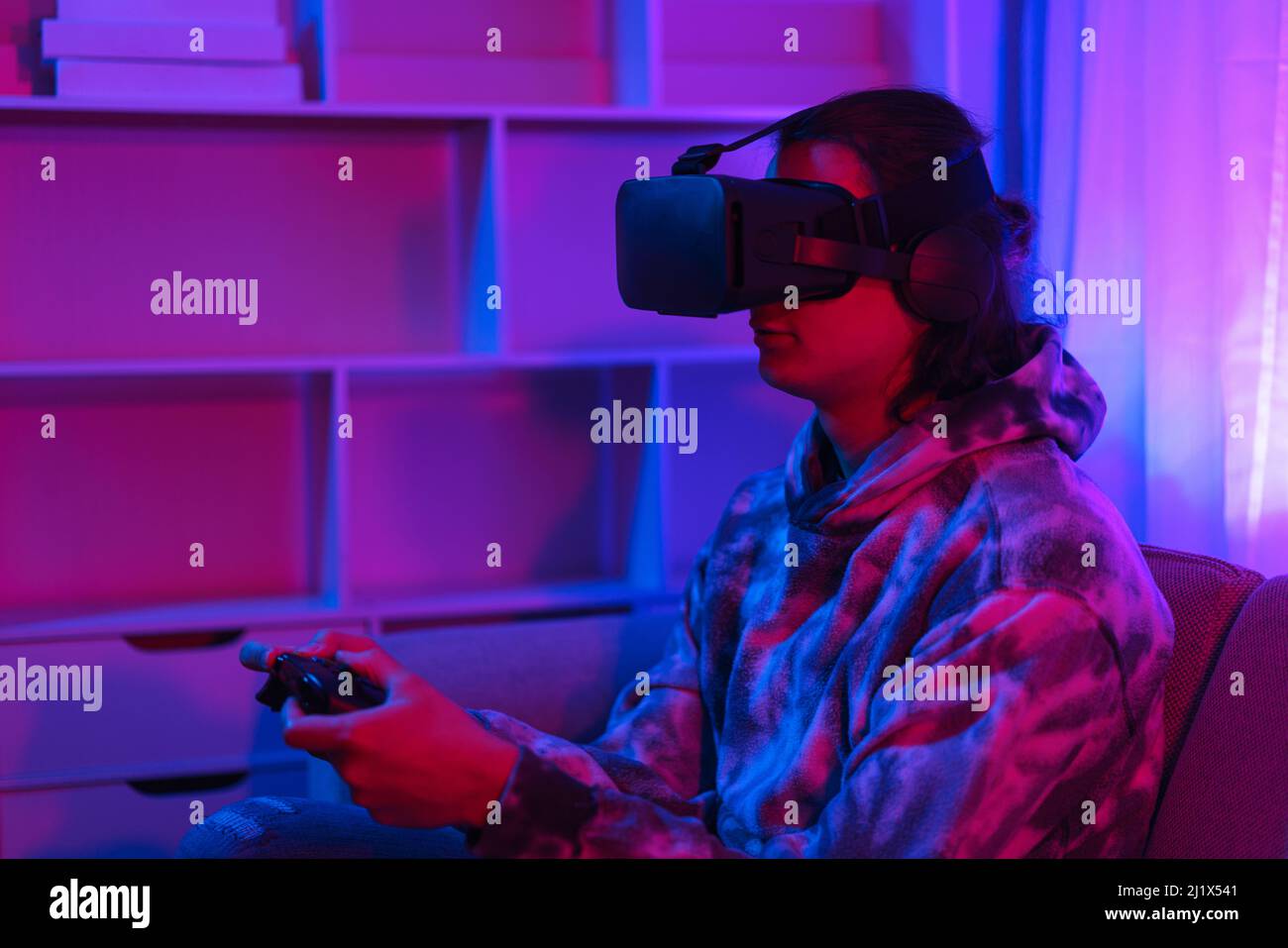 Metaverse technology concept, Man wear VR goggles and using joystick to ...
