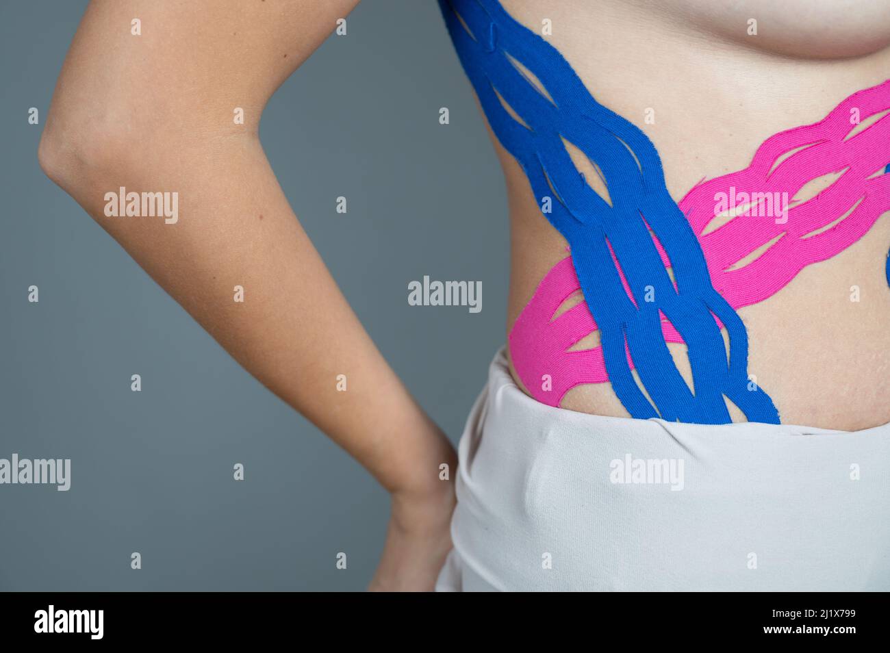 Close up of kinesiology tape on female body. Weight loss concept. Kinesio taping, sprains, injuries and muscle pain Stock Photo