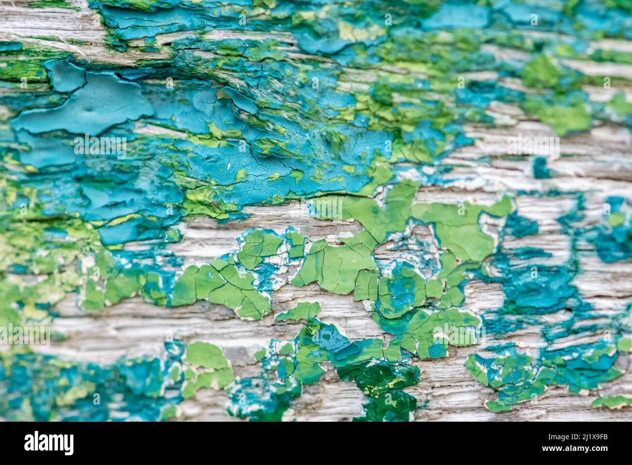 Flaked paint on a ship wreck, blue and green background Stock Photo
