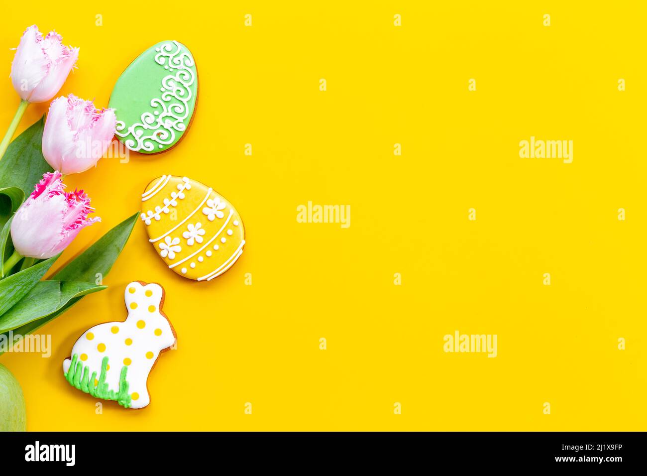 Happy Easter with pink tulips and cookies. Easter background Stock Photo