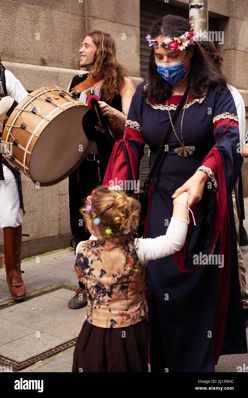 Vigo, Galicia, Spain, March 26 2022: Vertical photo of a mother teaching dancing to her daughter in a folk music festival in Galicia Stock Photo