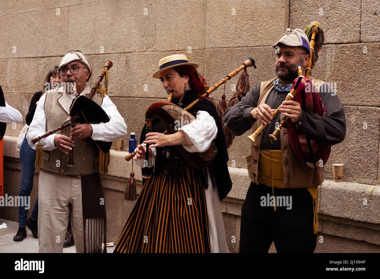 Vigo, Galicia, Spain, March 26 2022: A woman and two men playing Galician folk music wearing traditional costumes Stock Photo