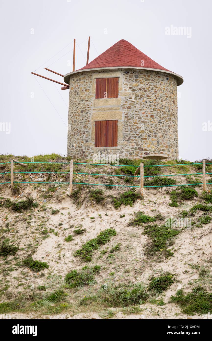 Hiking in Portugal on northwest coast in Apúlia beach near to windmills, tourism accommodation on windmills. Windmills near the ocean. Walking in Portugal. Stock Photo