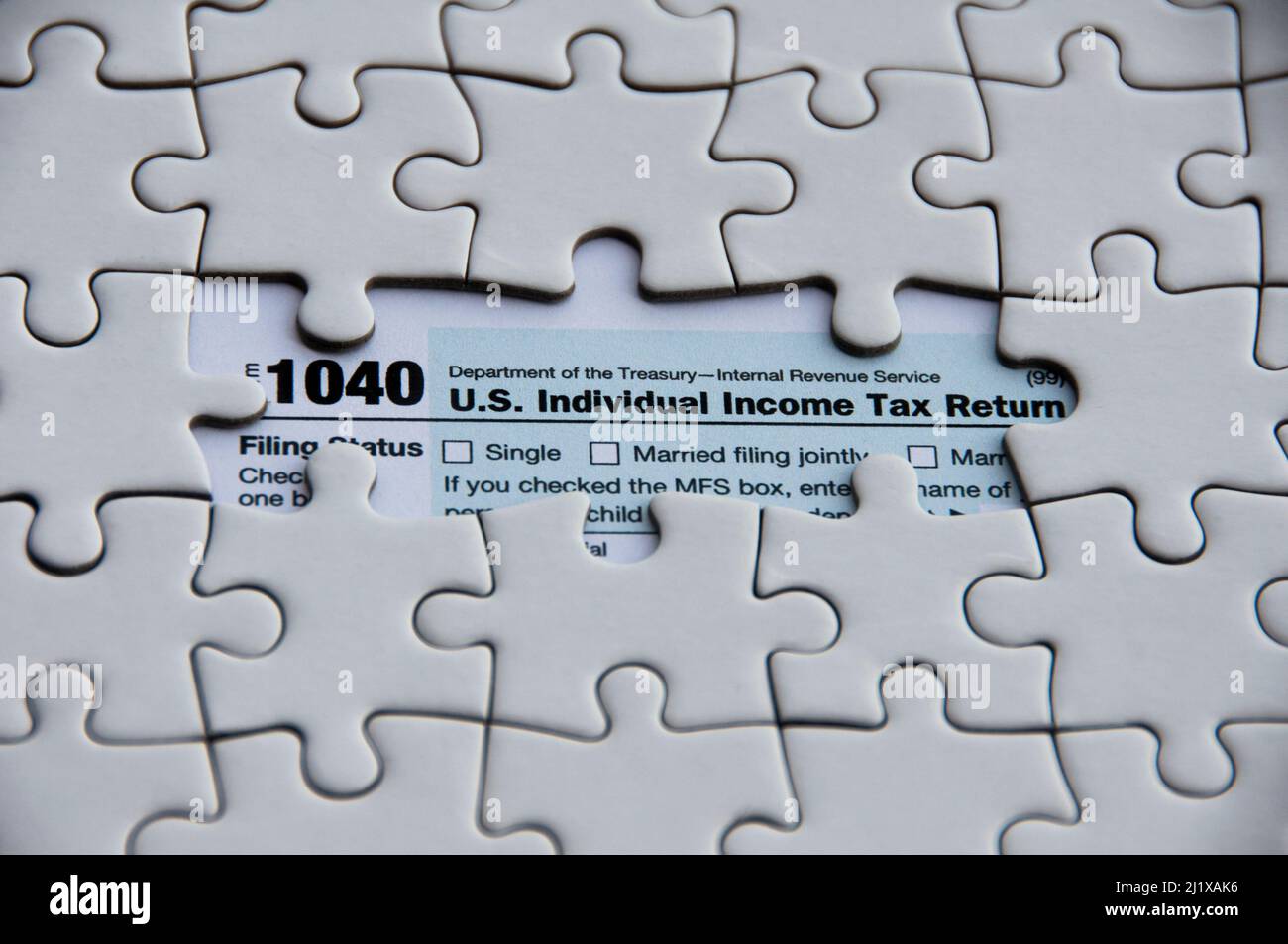 Top view of tax form with missing jigsaw puzzle. Tax concept Stock