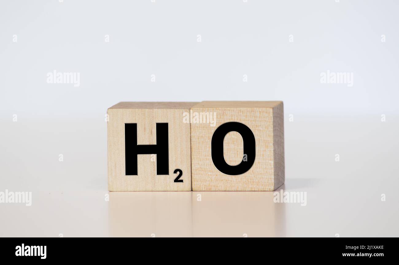 H2O - water chemical symbol in vintage wood letterpress printing blocks, stained by color inks, isolated on white. Stock Photo
