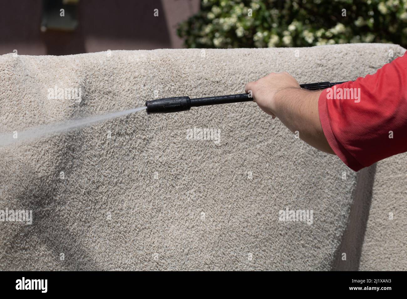 Washing carpets with high pressure washer. Cleaning the carpet with a