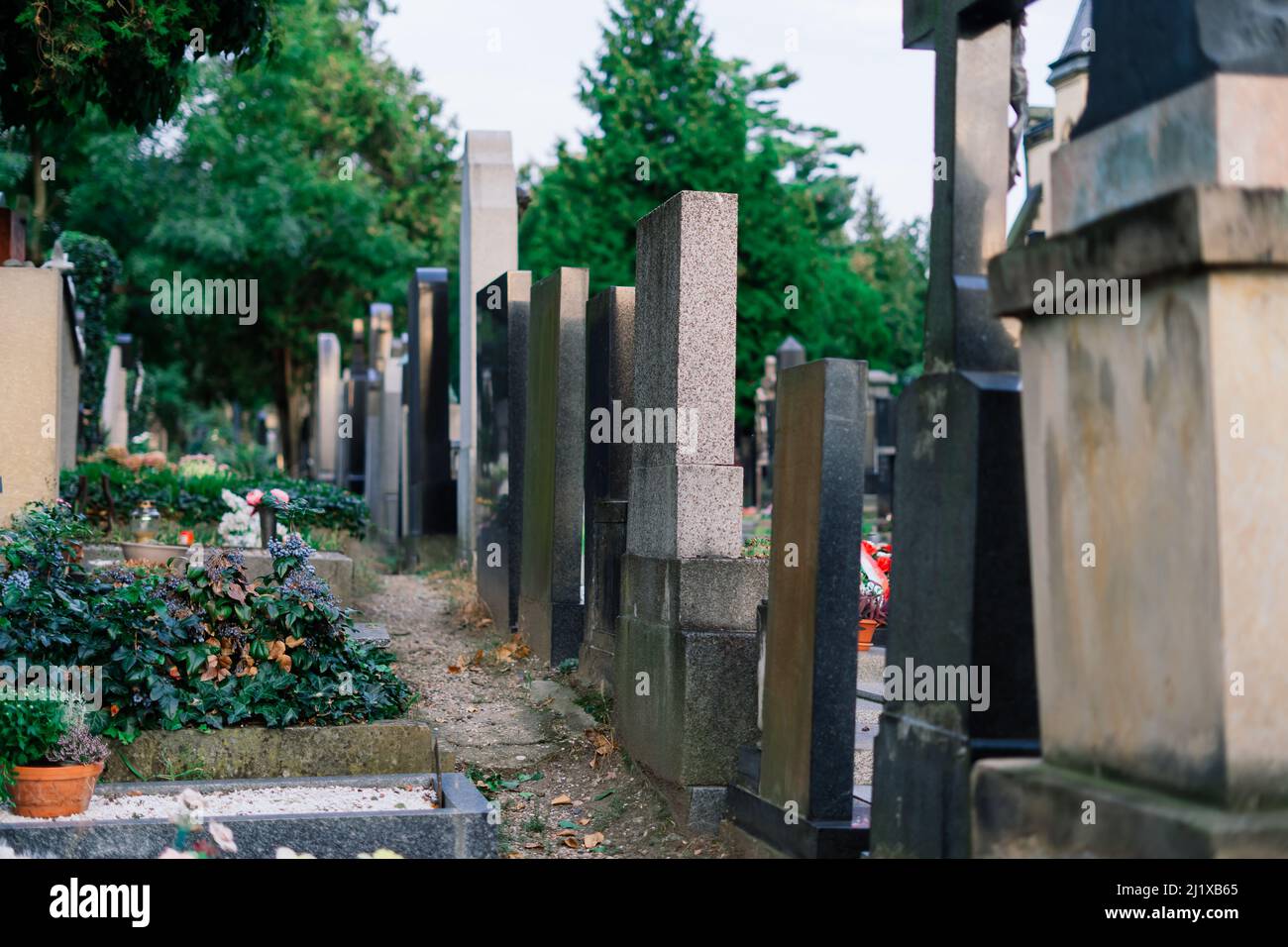 Cemetery statues, a despairing woman statue, crosses, resting place graveyard sculpture, art Stock Photo