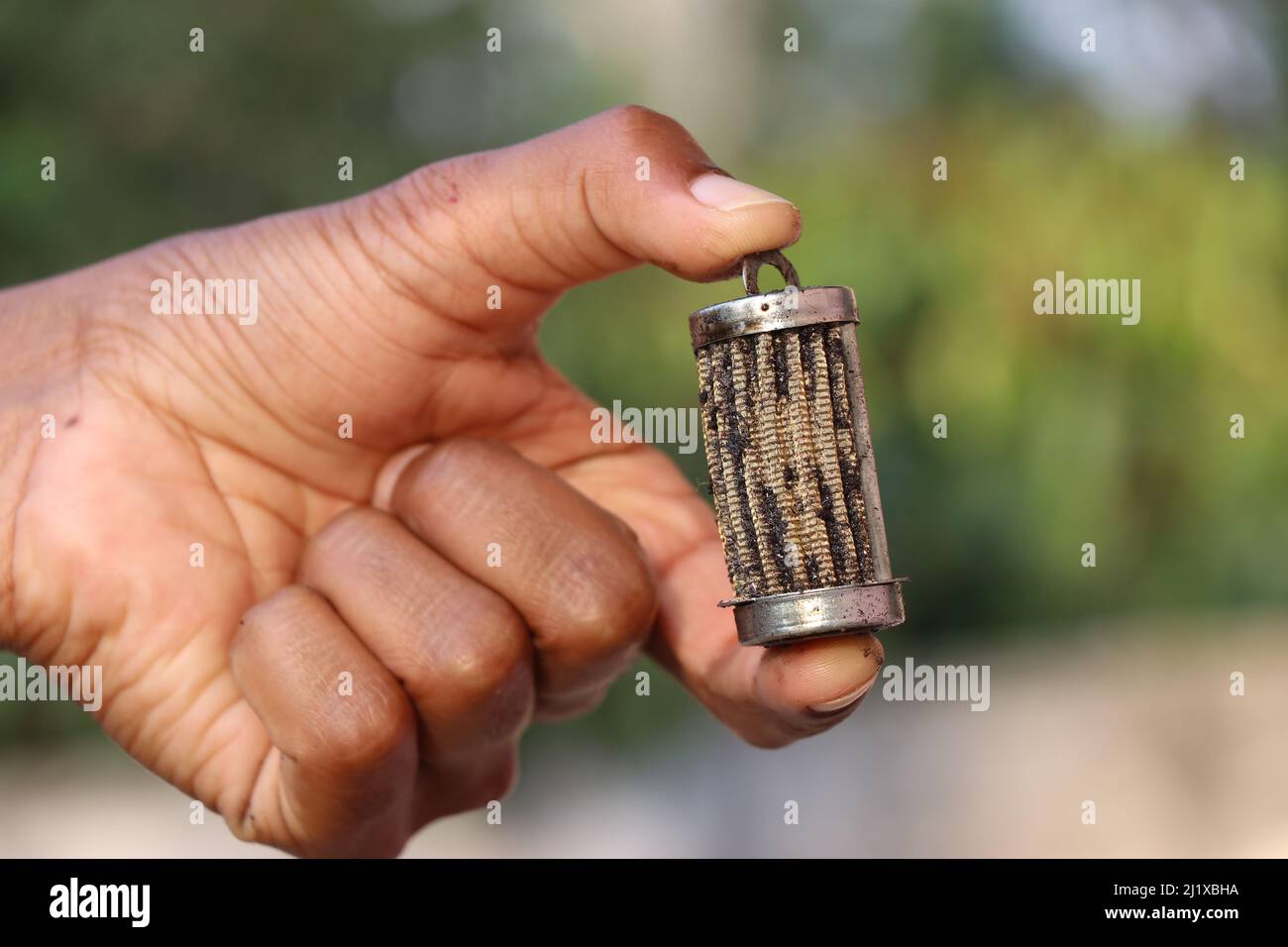 Used oil filter found from diesel engine held in the hand Stock Photo