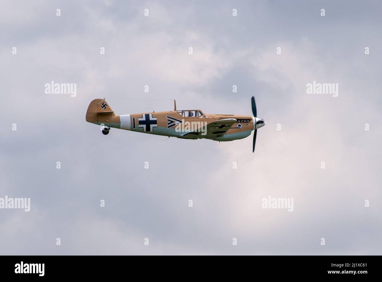 DUXFORD, CAMBRIDGESHIRE, UK - JULY 13, 2014: WW2 Bf (Messerschmitt) 109 carries out a dogfight display at Duxford airfield during Flying Legends Stock Photo