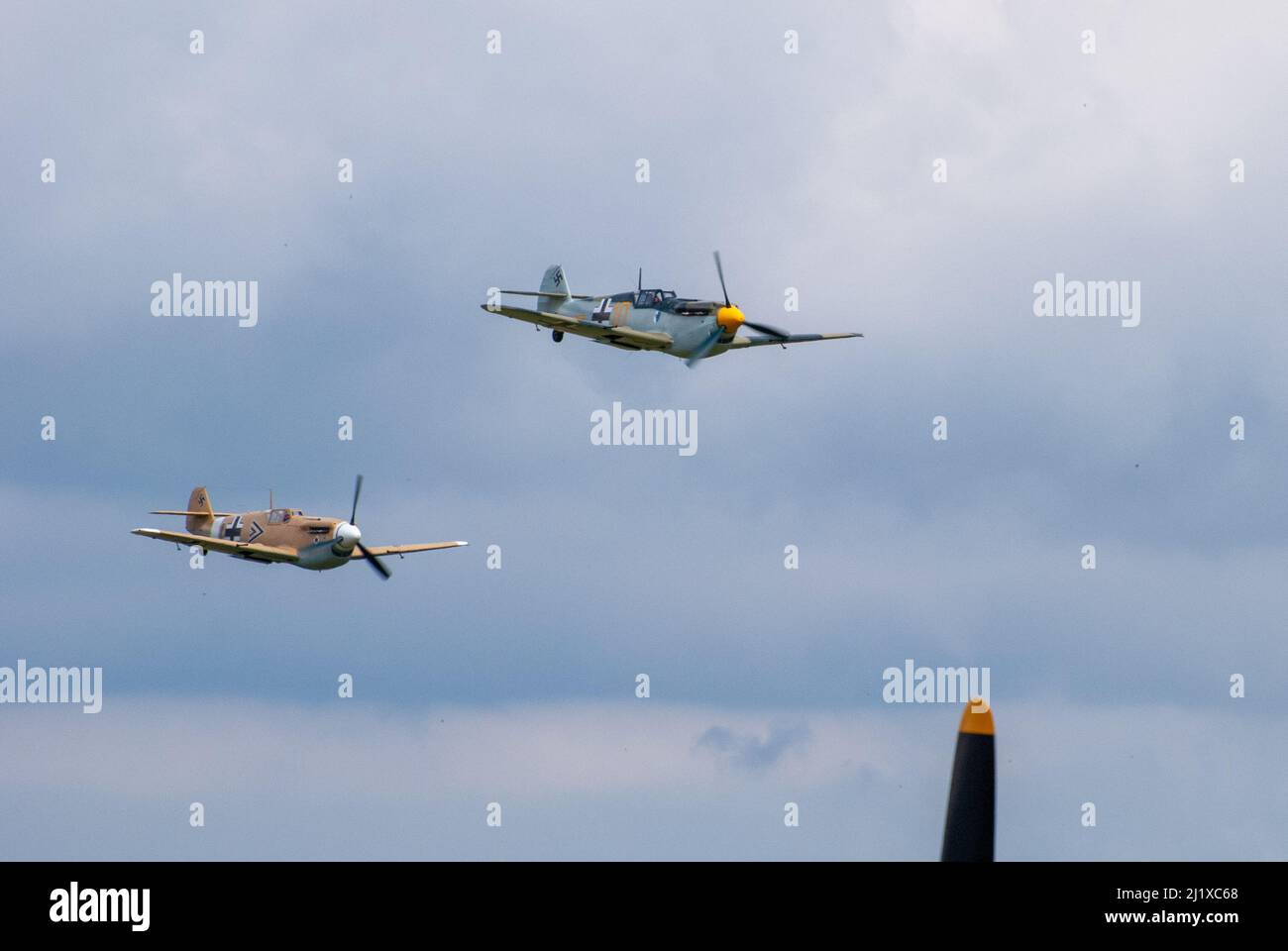 DUXFORD, CAMBRIDGESHIRE, UK - JULY 13, 2014: WW2 Bf (Messerschmitt) 109 carries out a dogfight display at Duxford airfield during Flying Legends Stock Photo
