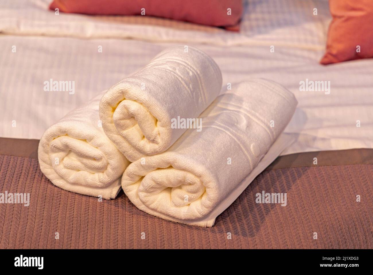 Three Clean White Towels Rolled at Bed in Hotel Stock Photo Alamy