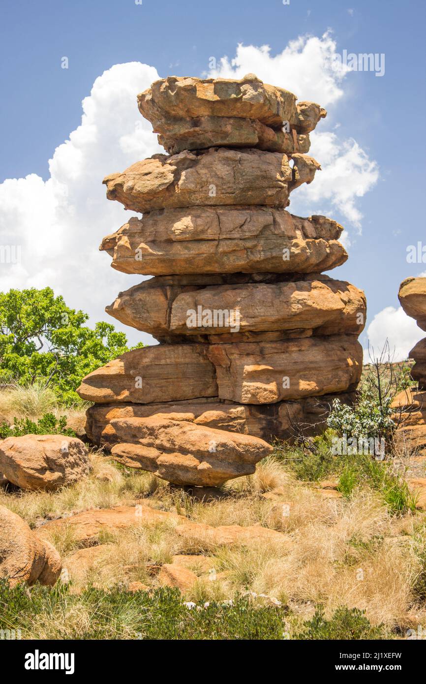 Bizarre rock pillar which looks like a stack of plates, on a sunny day in the Magaliesberg Mountains, South Africa Stock Photo