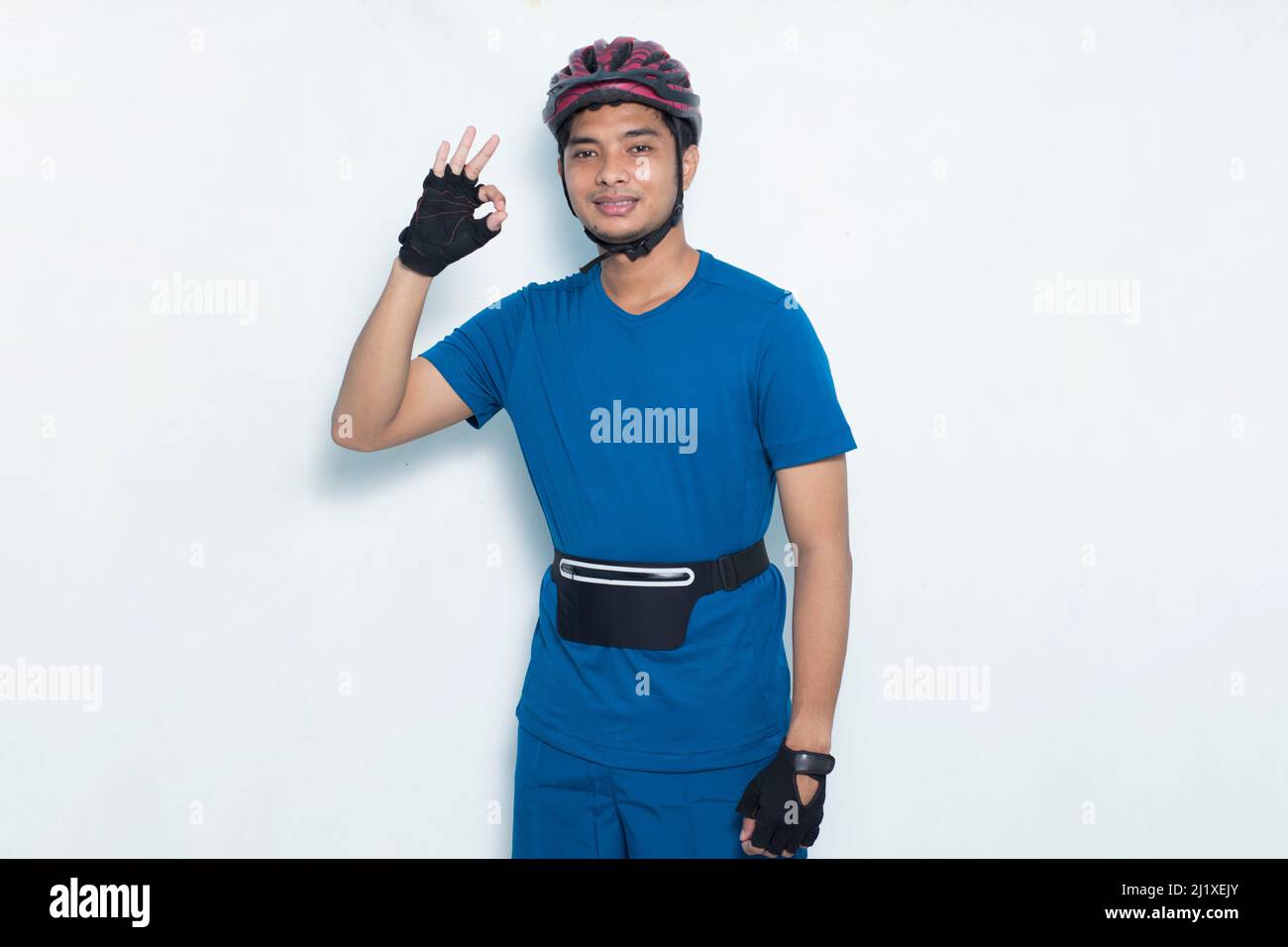 portrait young handsome asian man cyclist showing thumb up ok gesture isolated on white background Stock Photo