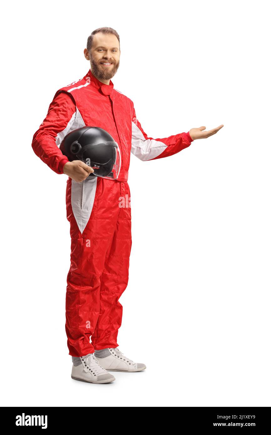 Full length shot of a car racer holding a helmet and showing with hand isolated on white background Stock Photo