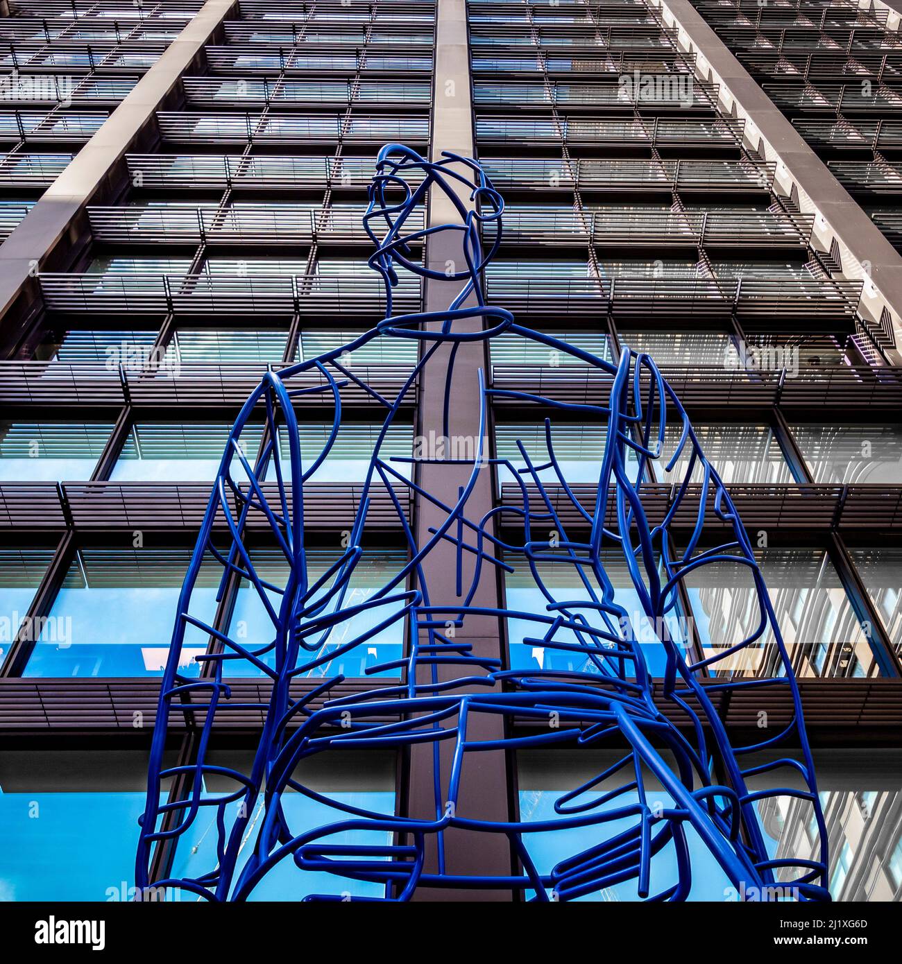 In Anticipation: Ultra-marine blue steel large-scale sculpture of a man situated in the piazza at Principal Place. London. UK Stock Photo