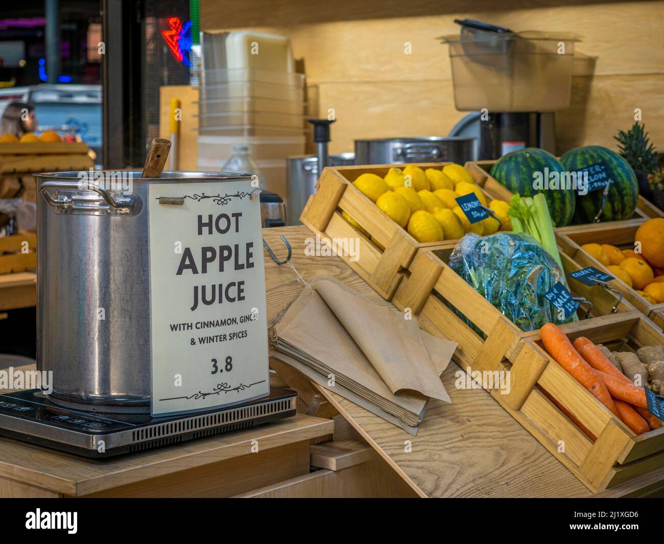 Large pan of hot apple juice for sale on a fruit and vegetable stall in Spitalfields market. London. Stock Photo