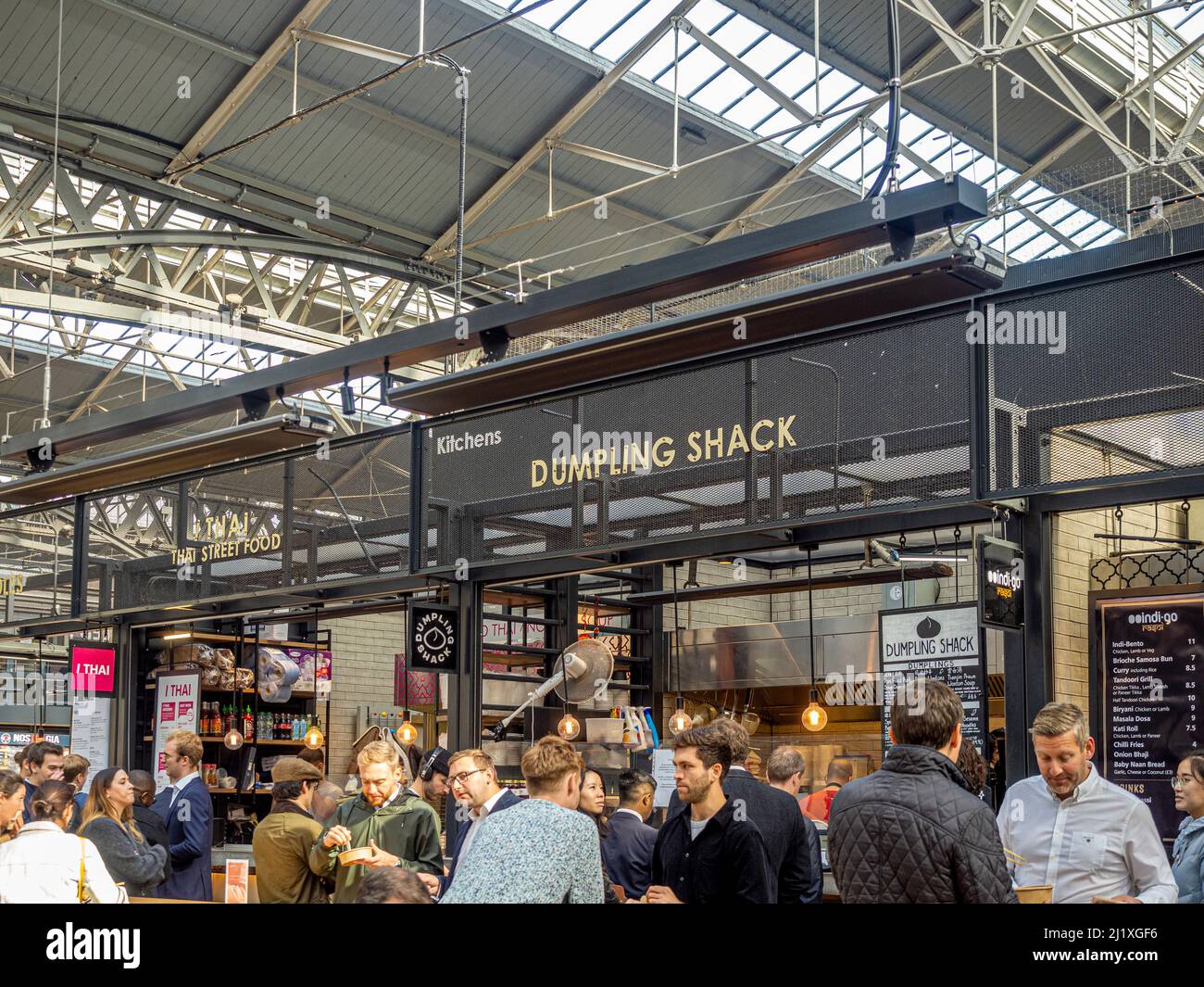 Lunchtime customers at The Dumpling Shack, situated in The Kitchens at Spitalfields Market. London. UK Stock Photo