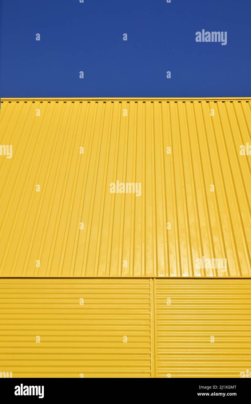 Background Pattern Yellow Galvanized Metal Profile Against the Sky Stock Photo