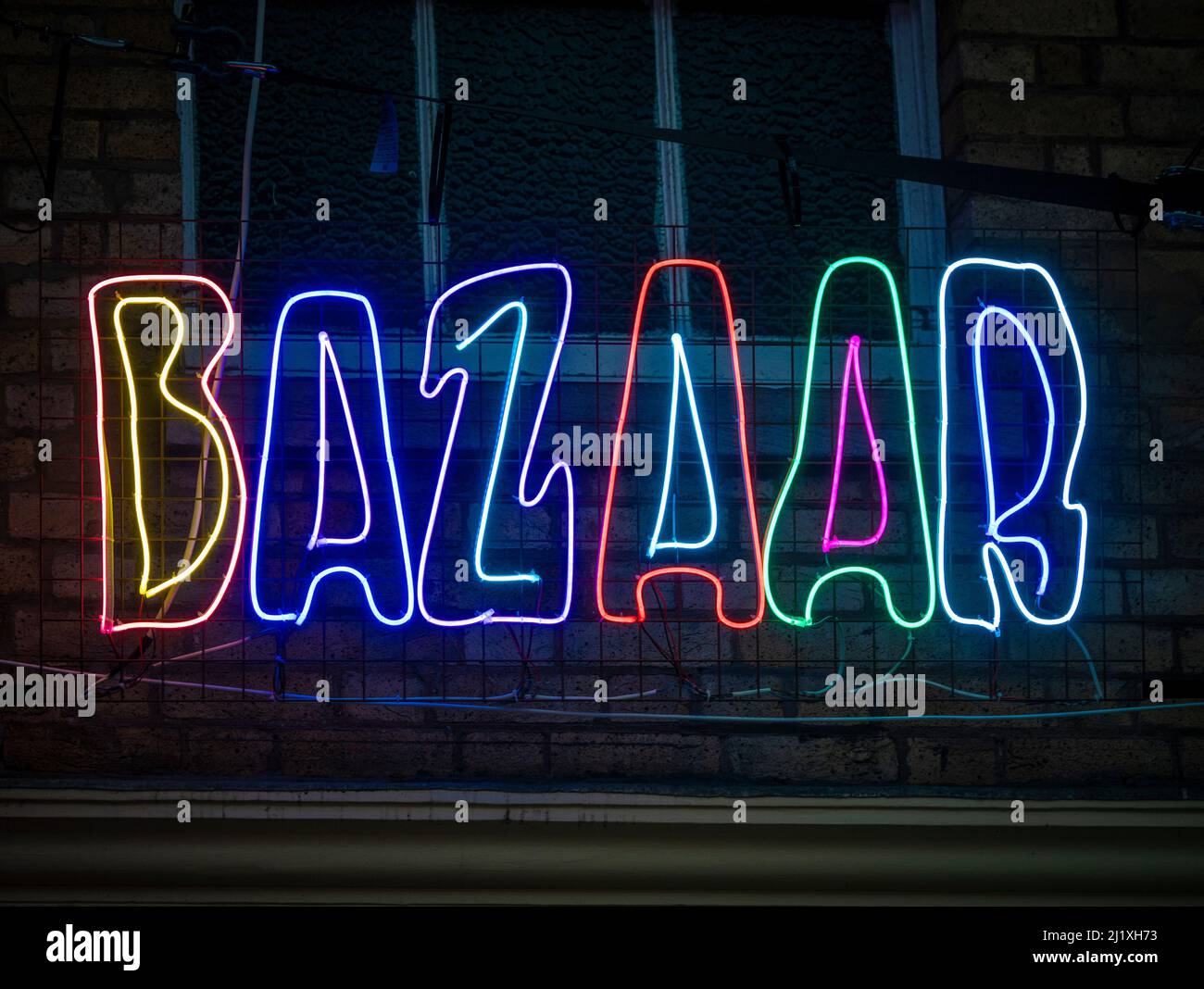 Neon light word 'Bazaar' part of an art installation by Chila Burman at Covent Garden, London. Stock Photo