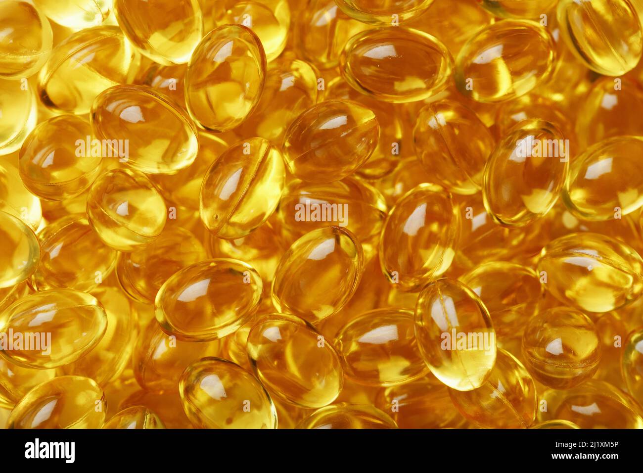 Golden Vitamin D3 Capsules close-up in full screen.The most important ...